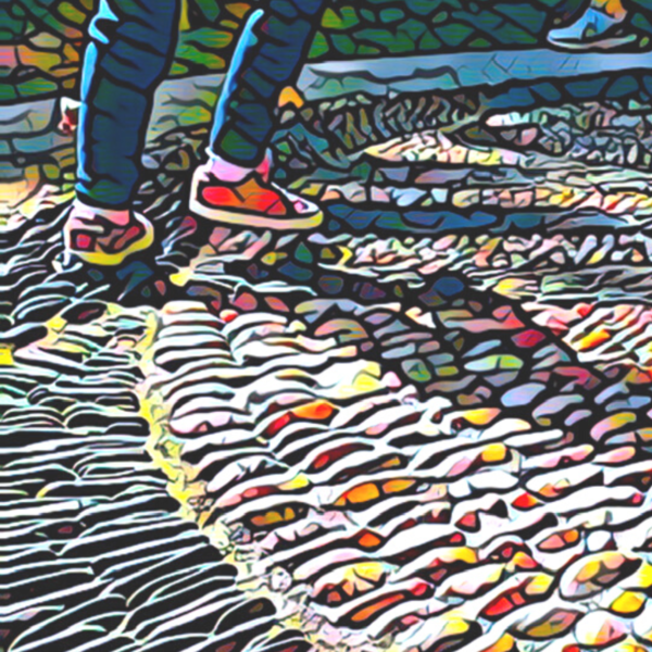 People stand on a large pebble mosaic.