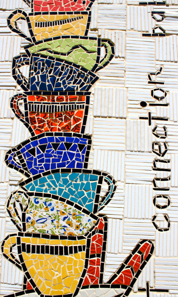 Image of a mosaic with a stack of colourful tea cups next to the word, “connection.”